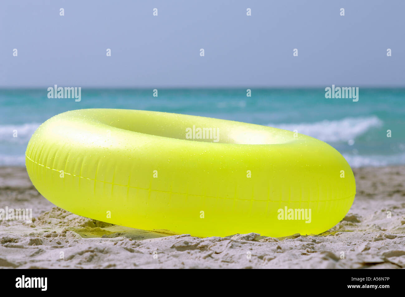 Inflatable ring in sand Stock Photo - Alamy