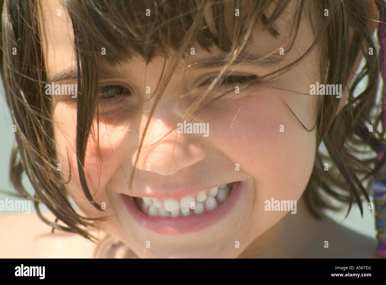 a young girl smiling at the camera Stock Photo - Alamy