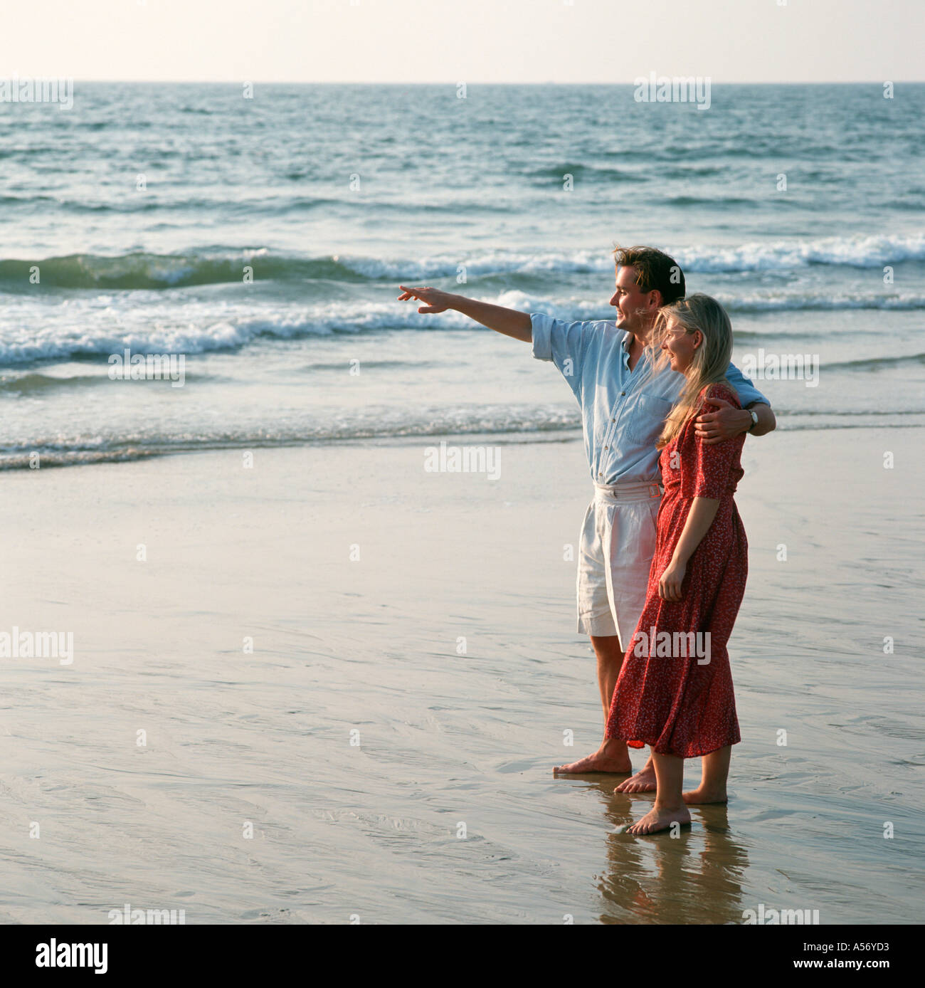 Intimate couple on beach hi-res stock photography and images - Alamy