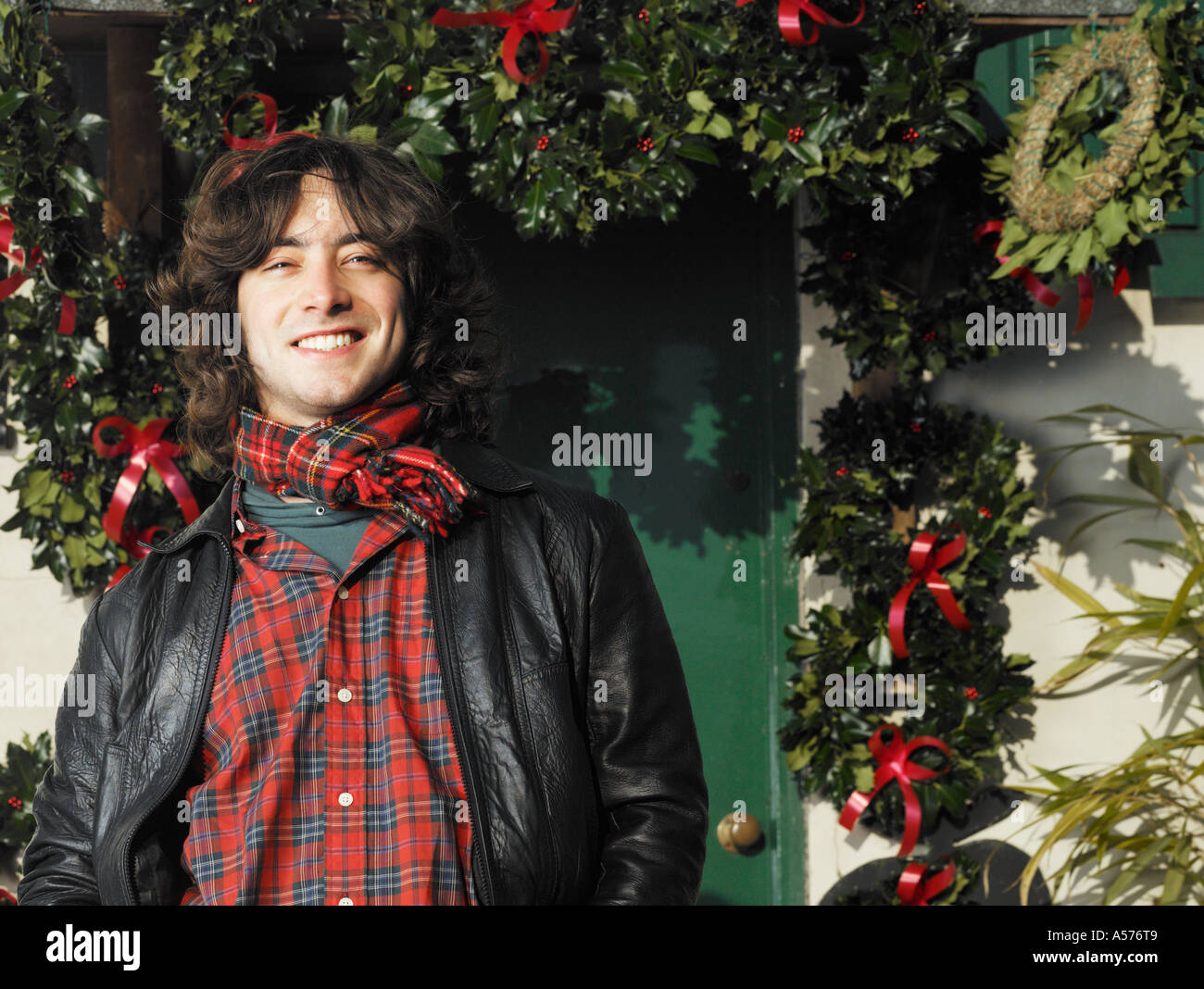 Young man outside with natural christmas decorations Stock Photo
