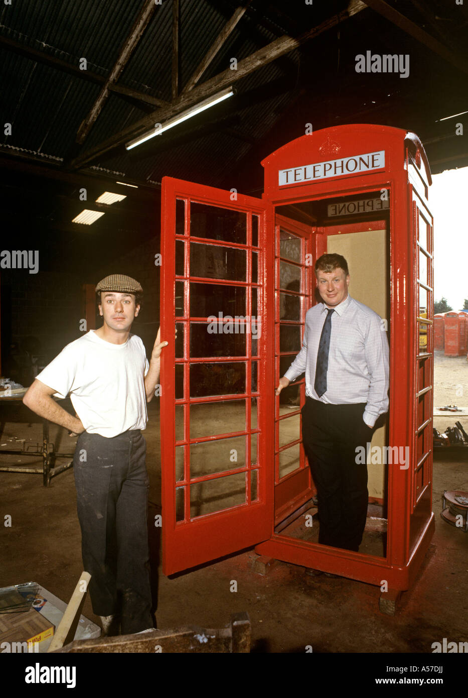 K6 Phone box Willy White and Harry Villiers with box being restored Fyfield Essex Stock Photo