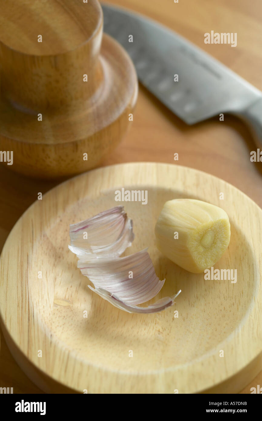 Garlic clove ready to crush Stock Photo Alamy