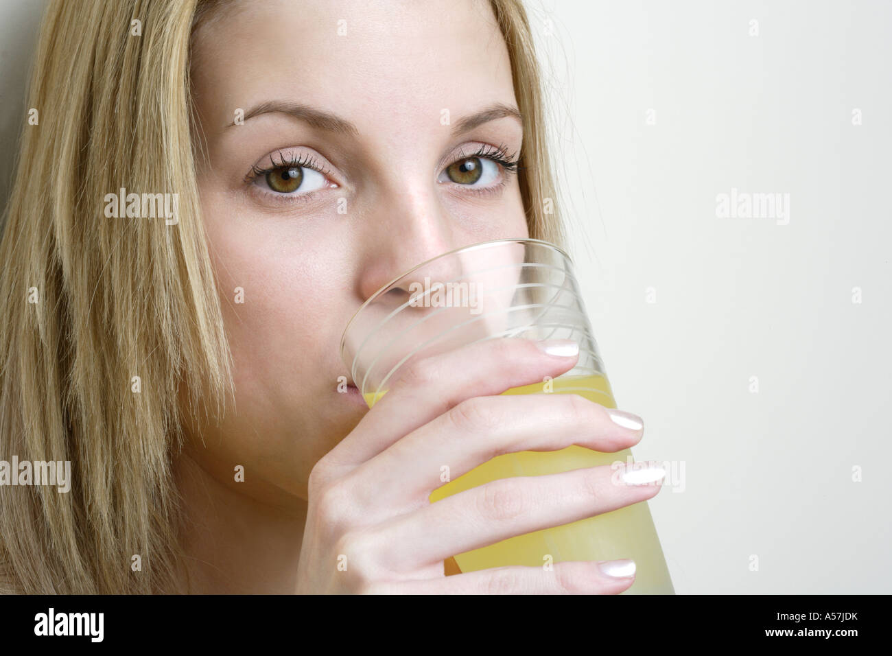 Young woman drinking orange juice close up Stock Photo Alamy