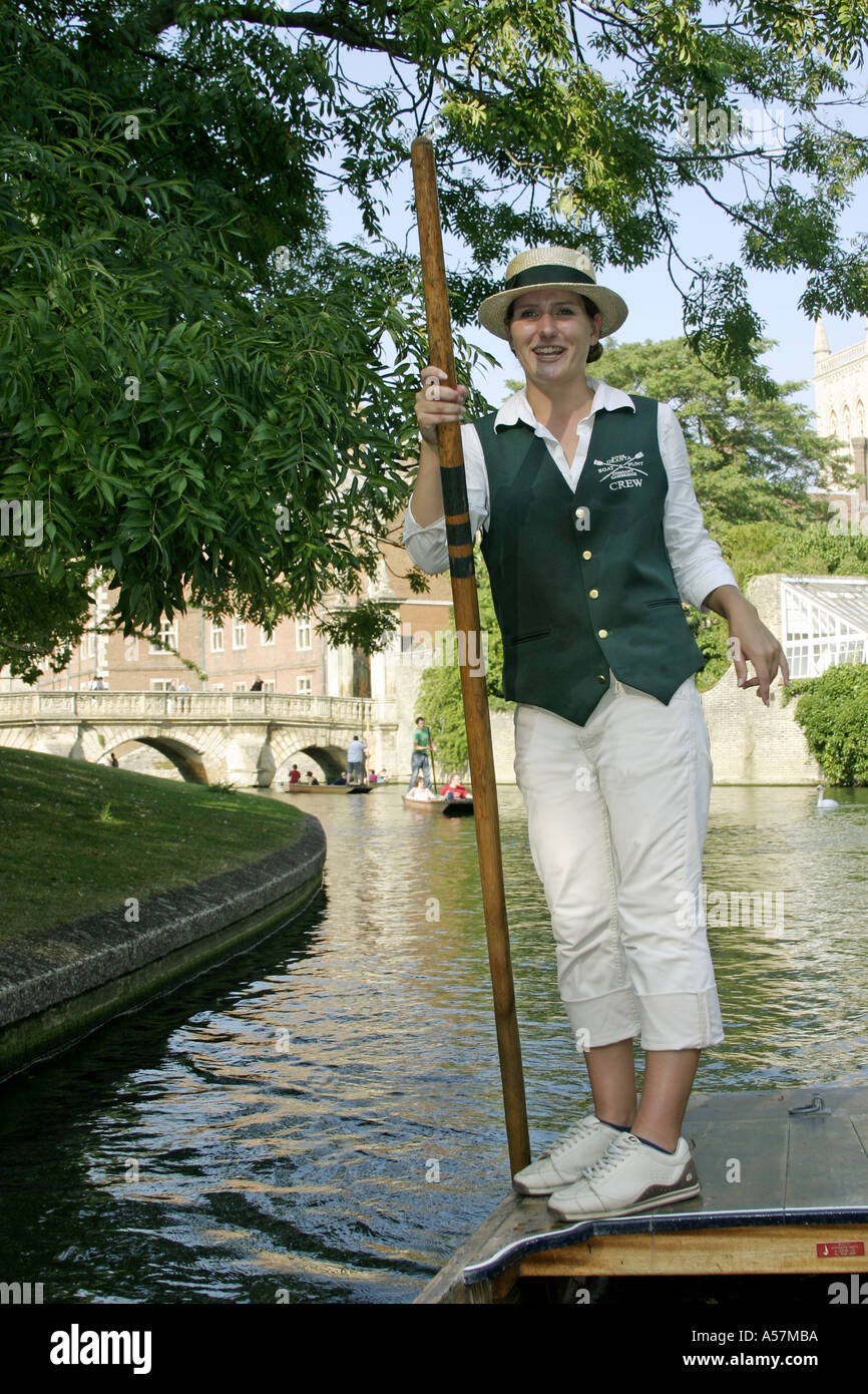 Female punt chauffeur punting on River Cam in Cambridge England Stock Photo