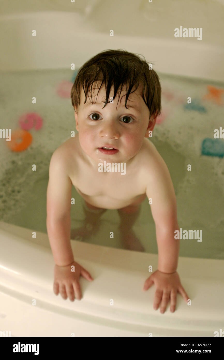 baby standing in bathtub