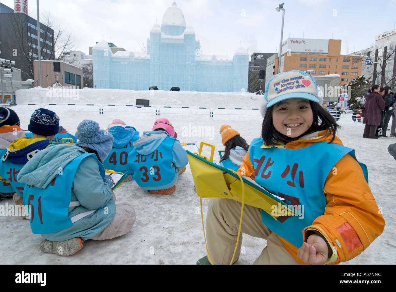 Children sketching a large snow sculpture at the Sapporo Snow Festival 2006 Stock Photo