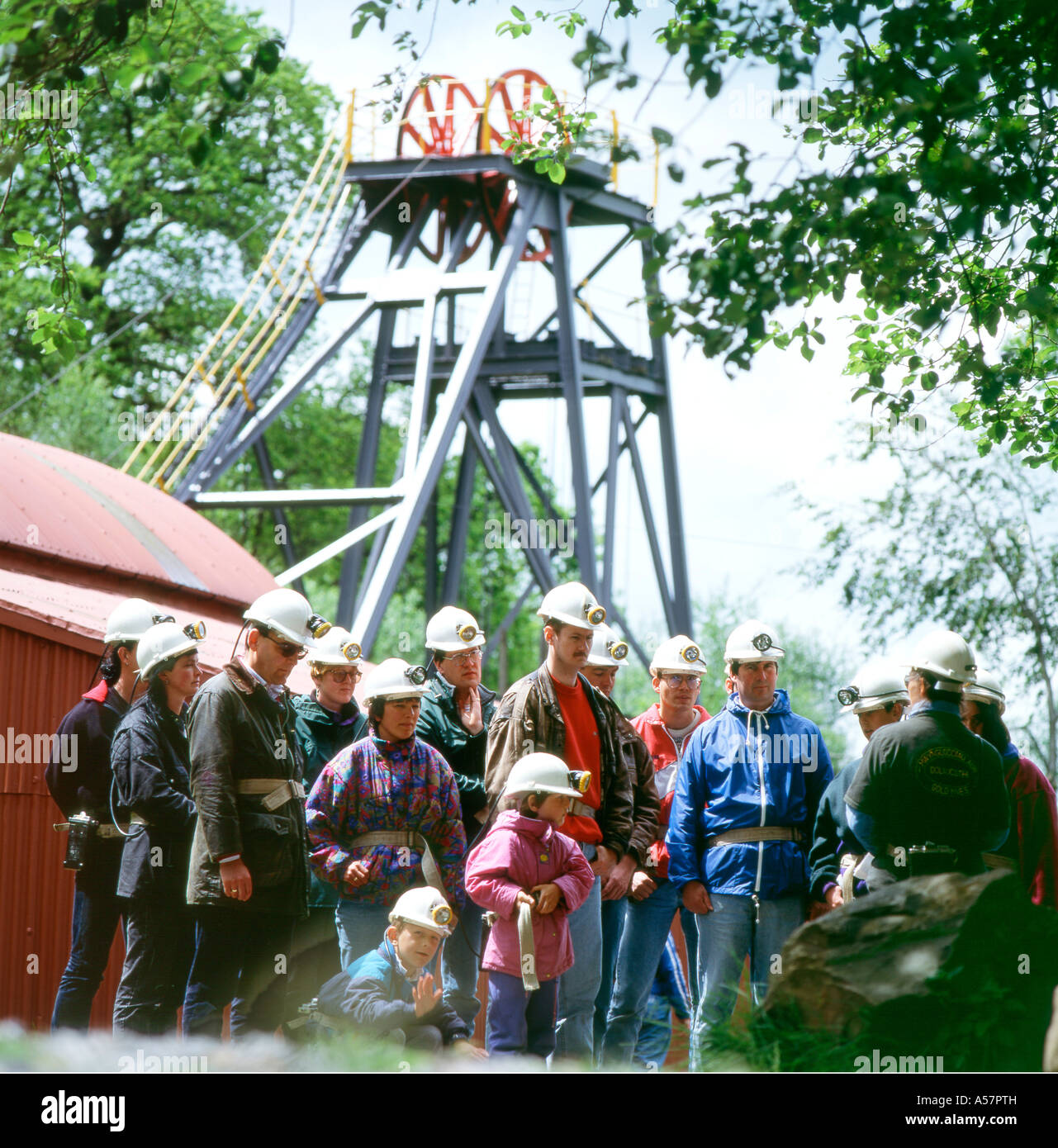 A group of tourists on a Dolau Cothi Gold Mine tour listening to a guide Pumpsaint, Carmarthenshire West Wales UK KATHY DEWITT Stock Photo