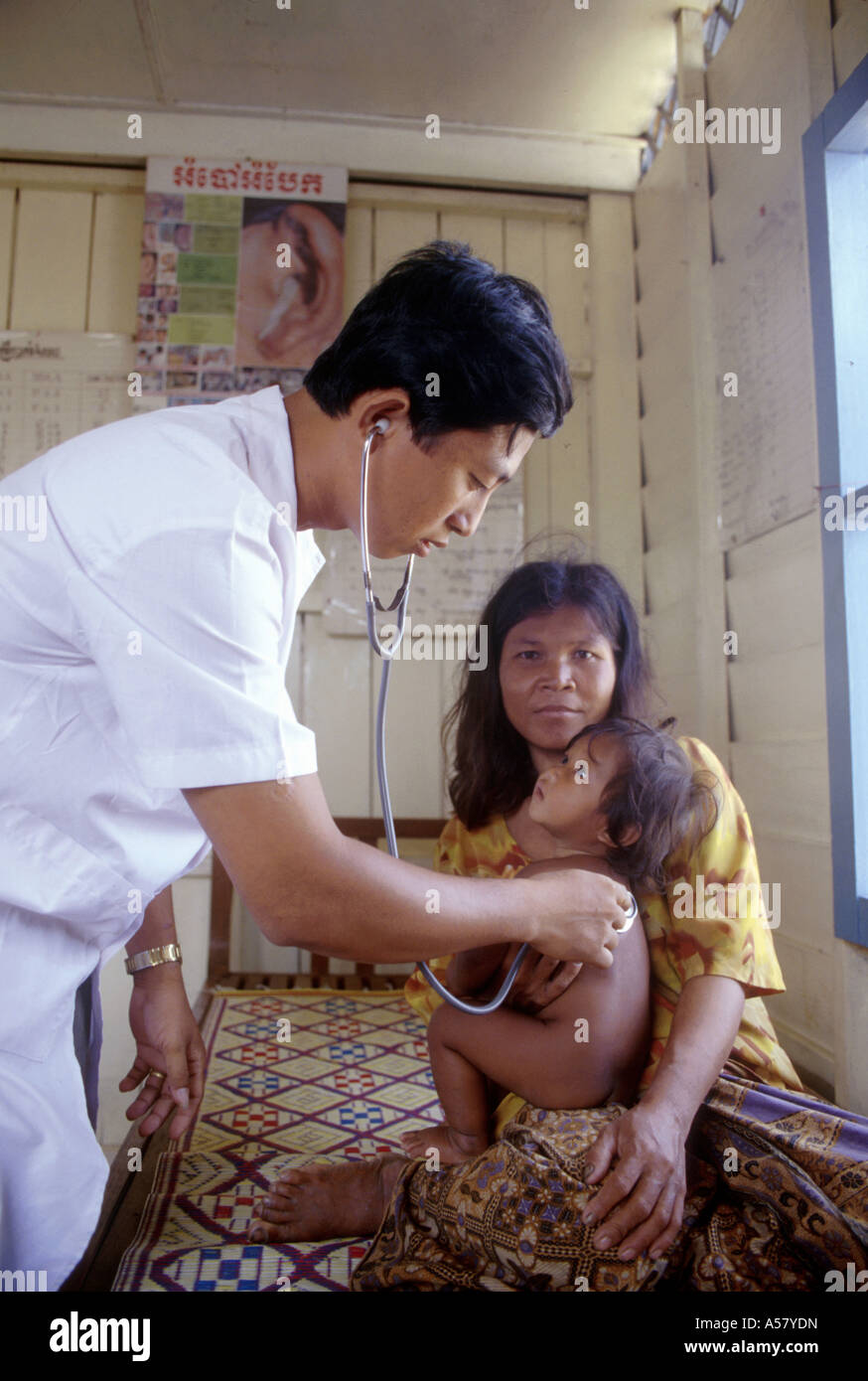 Painet ha2072 4166 doctor examing baby mother floating clinic siem reap cambodia country developing nation less economically Stock Photo