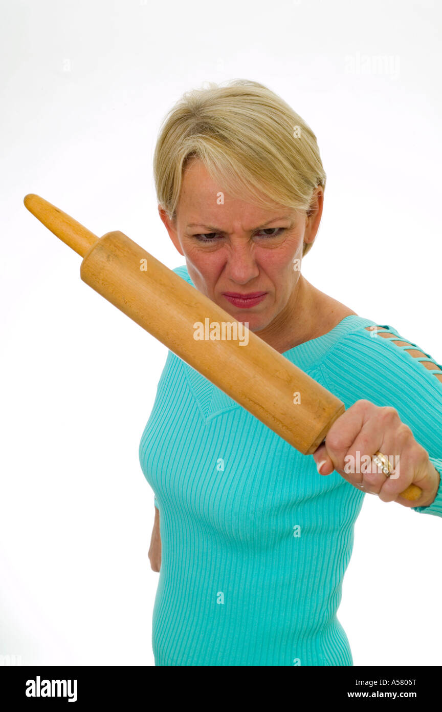 angry married woman threatening with a rolling pin Stock Photo