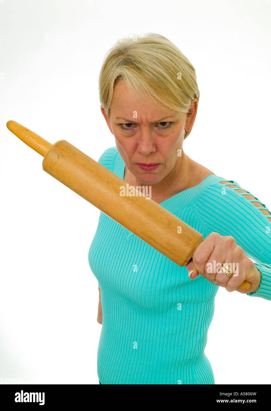angry married woman threatening with a rolling pin Stock Photo