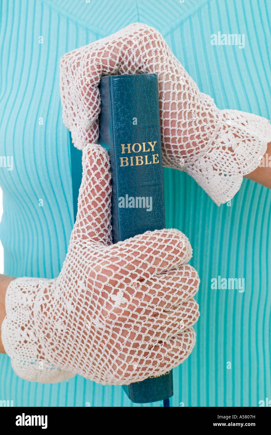 woman wearing white gloves and holding a bible Stock Photo Alamy