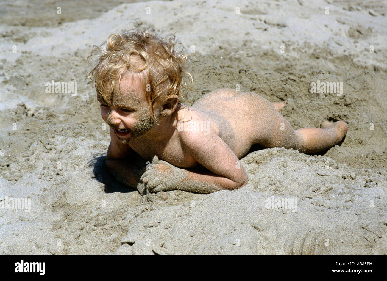 France Camargue Baby Girl Naked Playing On A Sandy Beach Stock Photo - Alamy