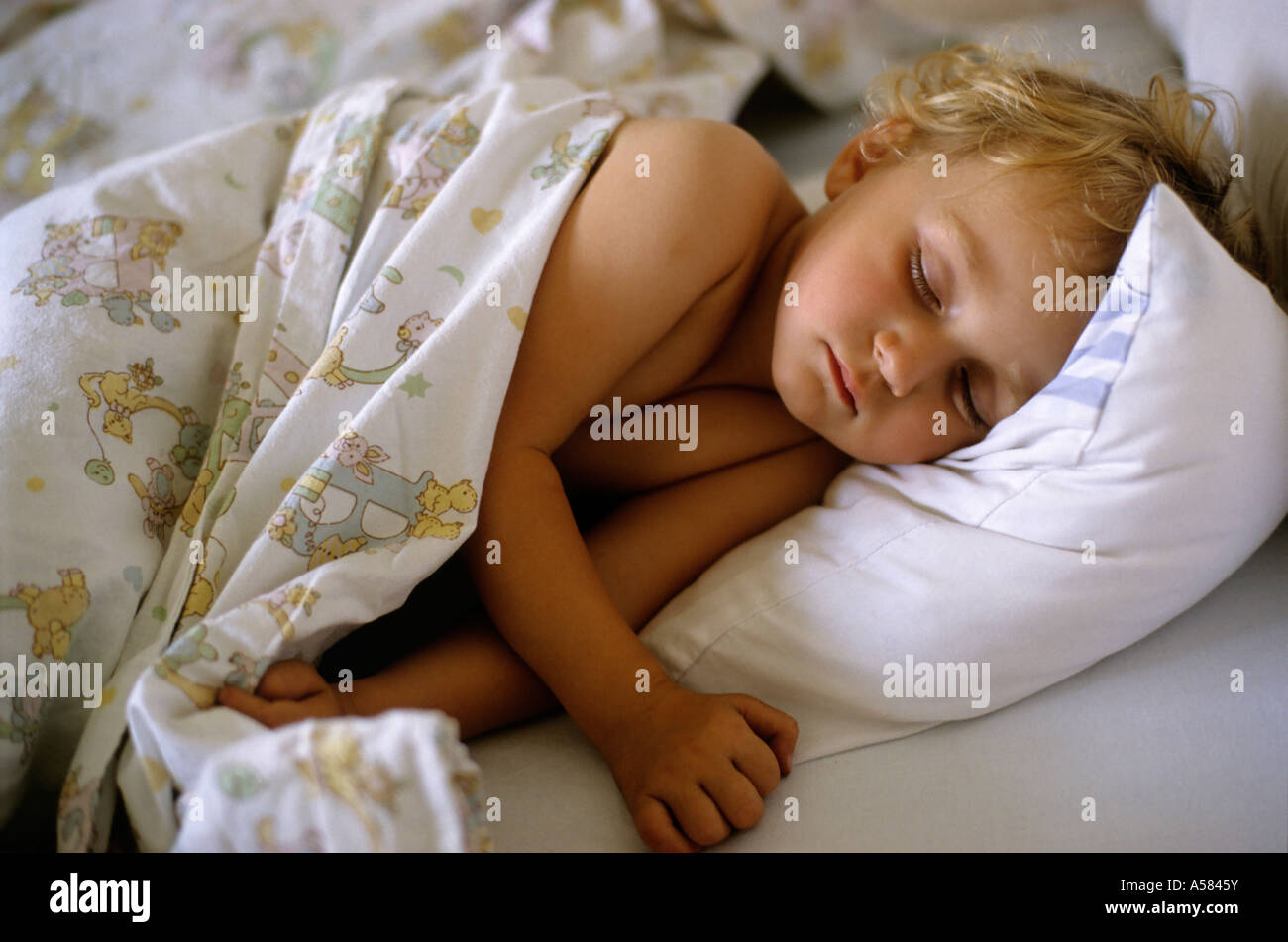 Two year old girl asleep in bed, France Stock Photo Alamy