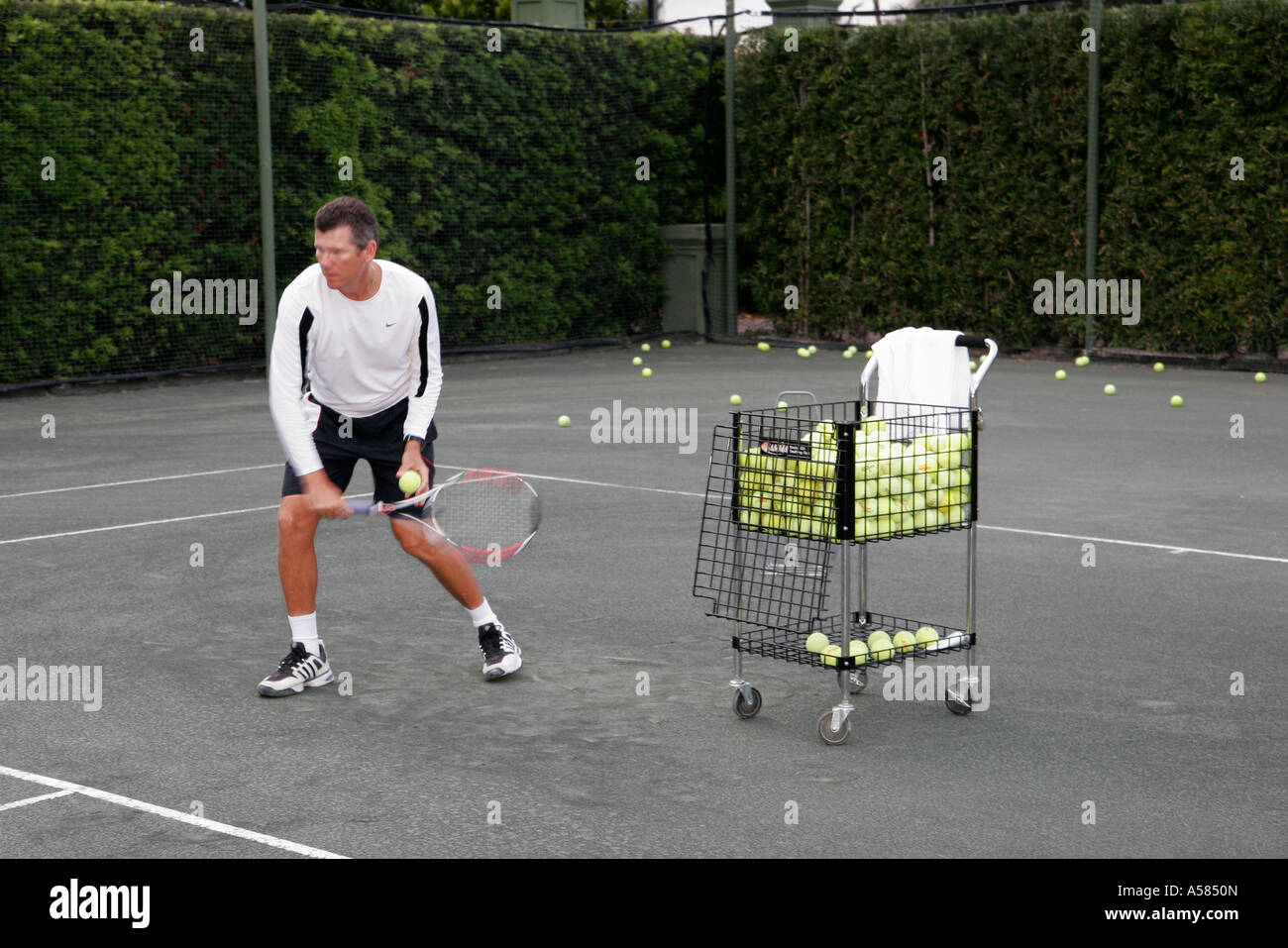 Miami Florida,Fisher Island,Tennis Club,adult adults man men male,tennis  pro,lessons,cart,basket,trolley,balls,court,racket,visitors travel  traveling Stock Photo - Alamy