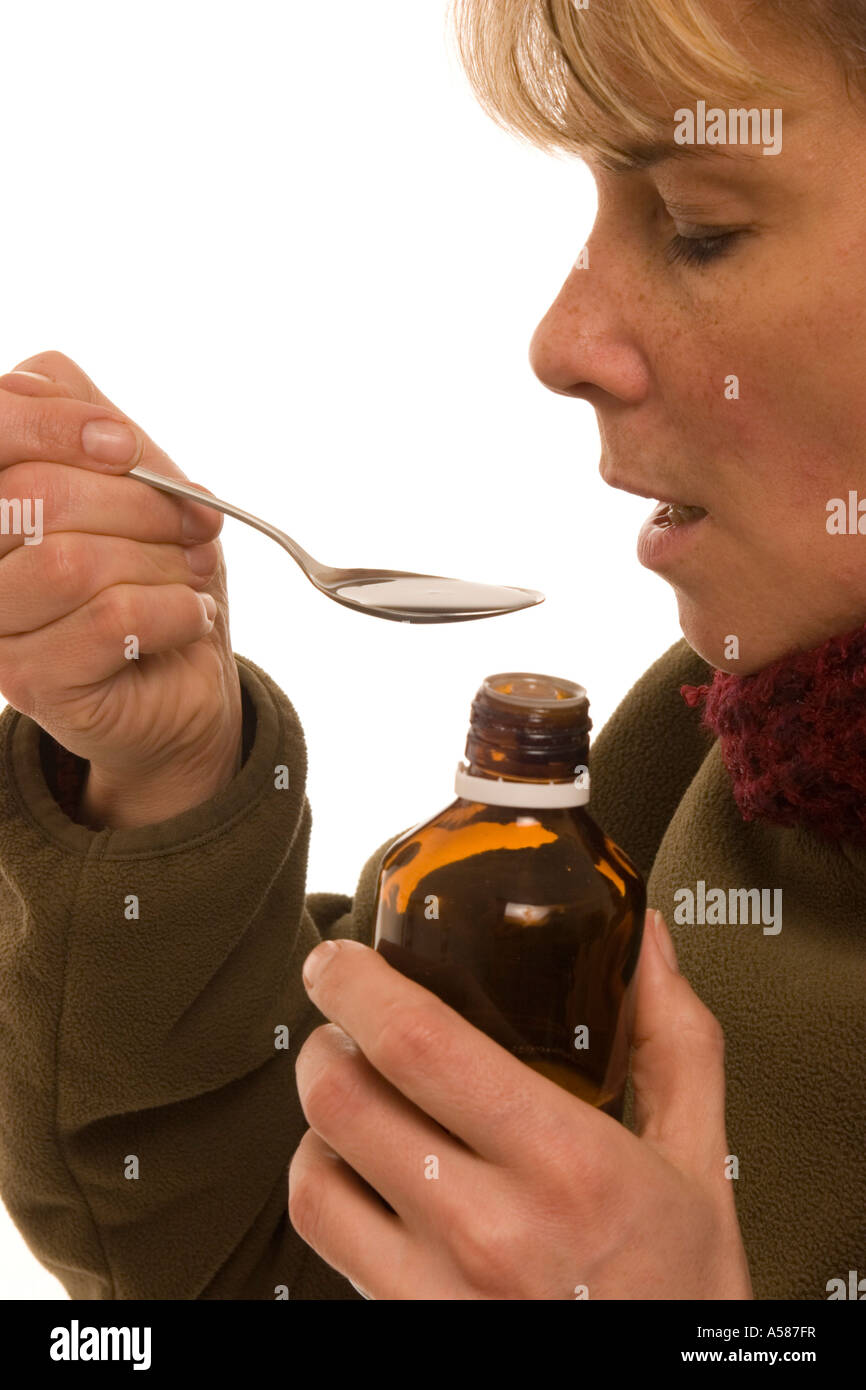 Woman taking cough syrup Stock Photo Alamy