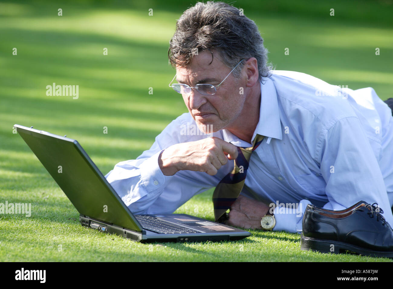 Manager working on notebook in parc Stock Photo