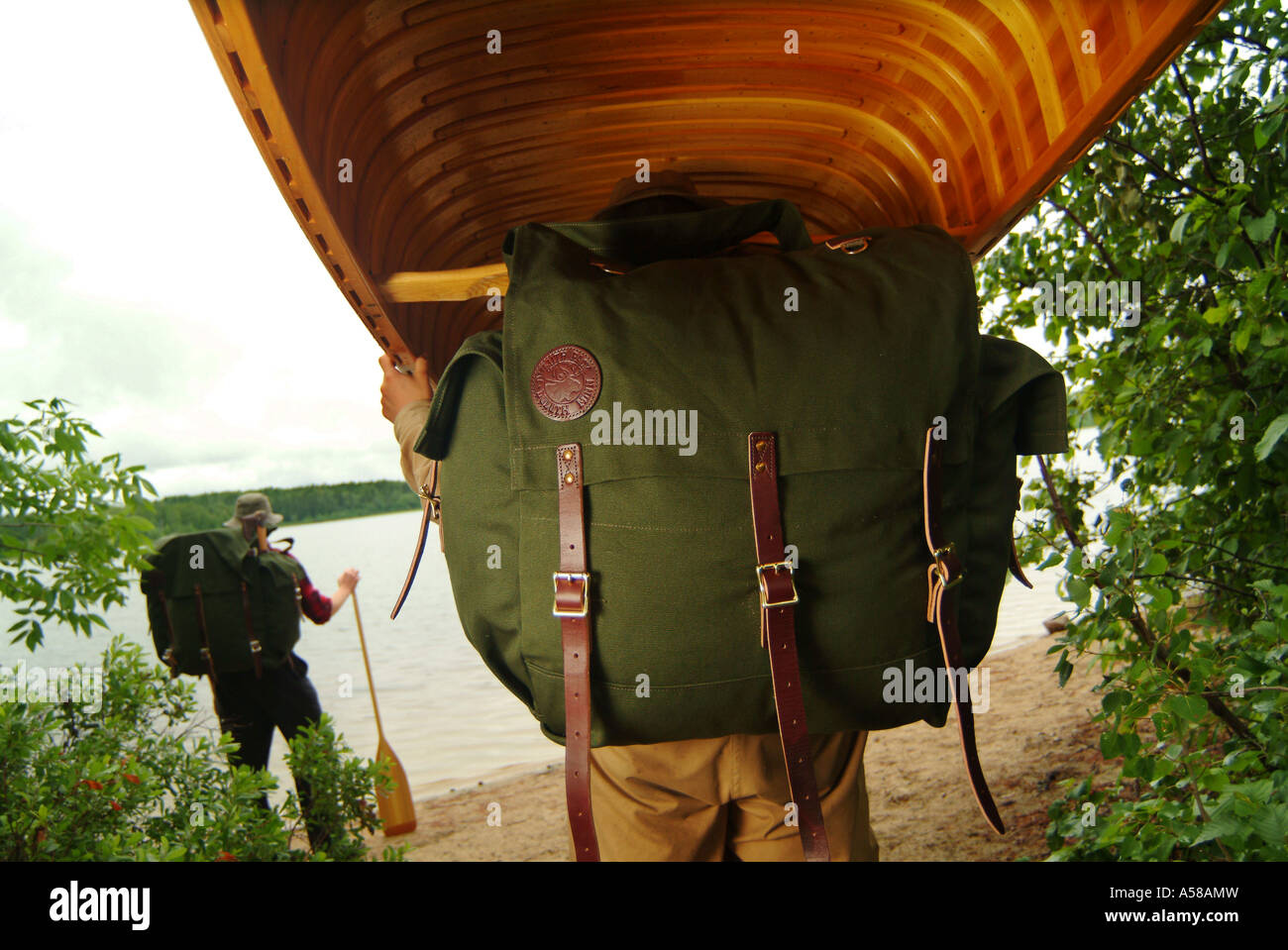 Portaging a wooden canoe in Boundary Waters Canoe Area Wilderness BWCAW