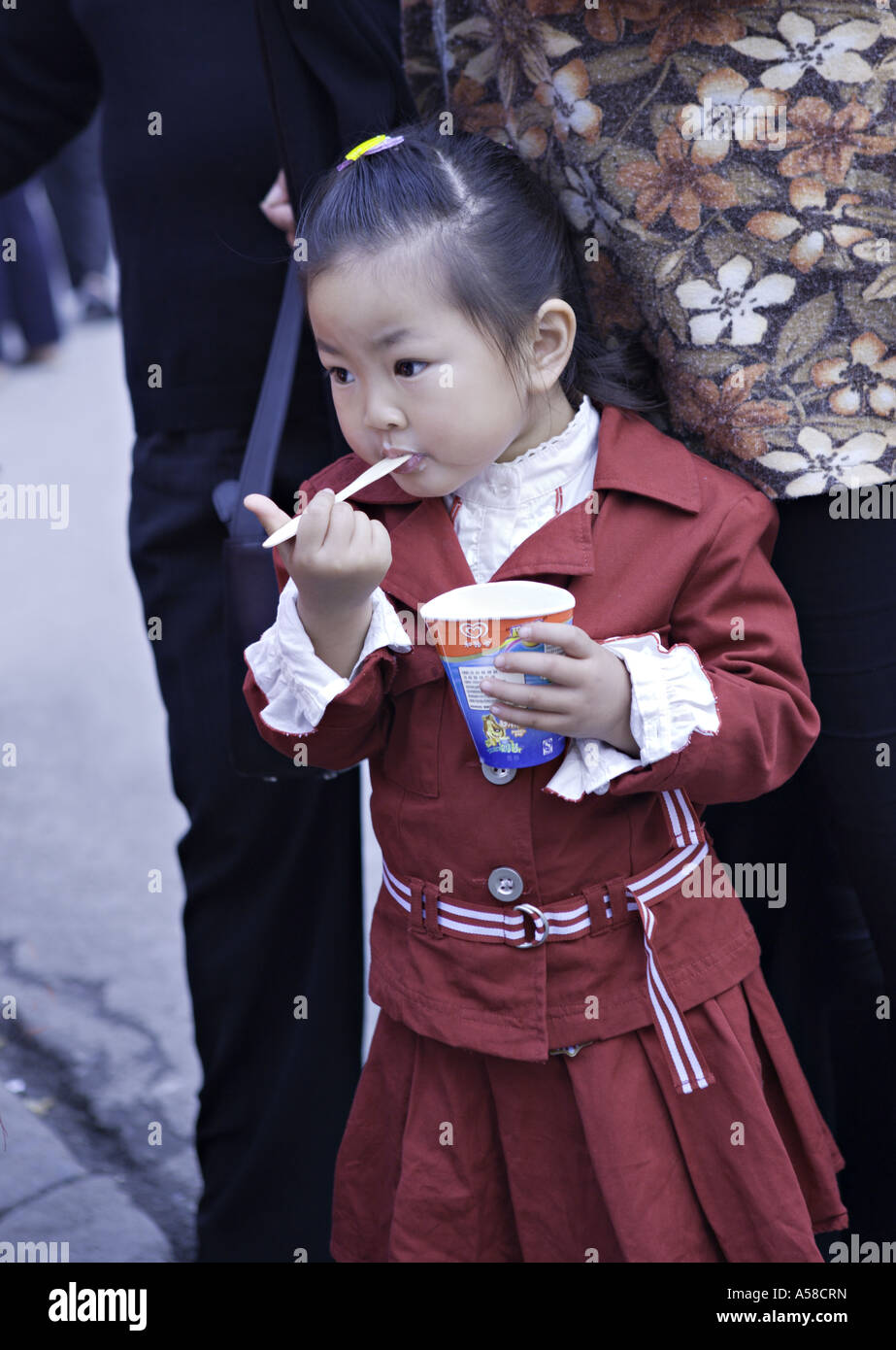 CHINA SHANGHAI Young Chinese girl eating Chinese brand ice cream in the ...