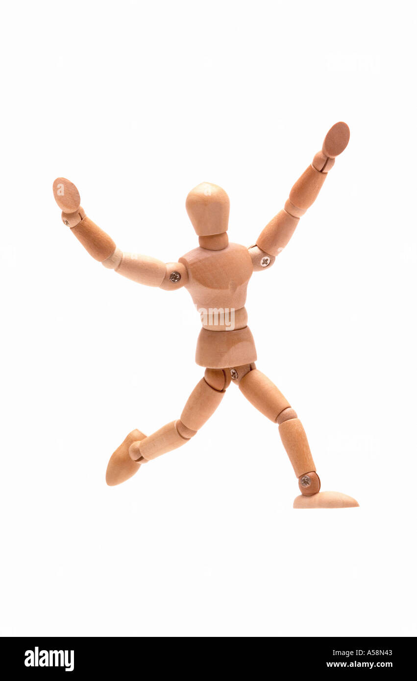 Leaping wooden figure against white background Stock Photo