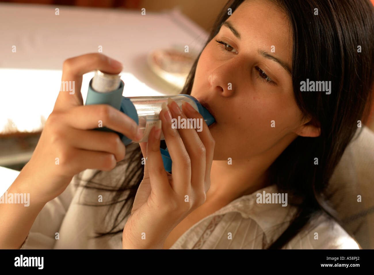 young woman with asthma inhaler Stock Photo