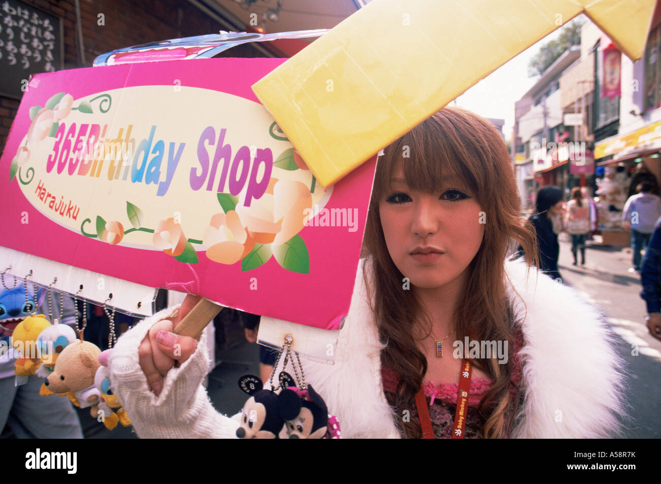 Japan, Tokyo, Harajuku, Takeshita Dori, Teenage Girl Holding Billboard Stock Photo