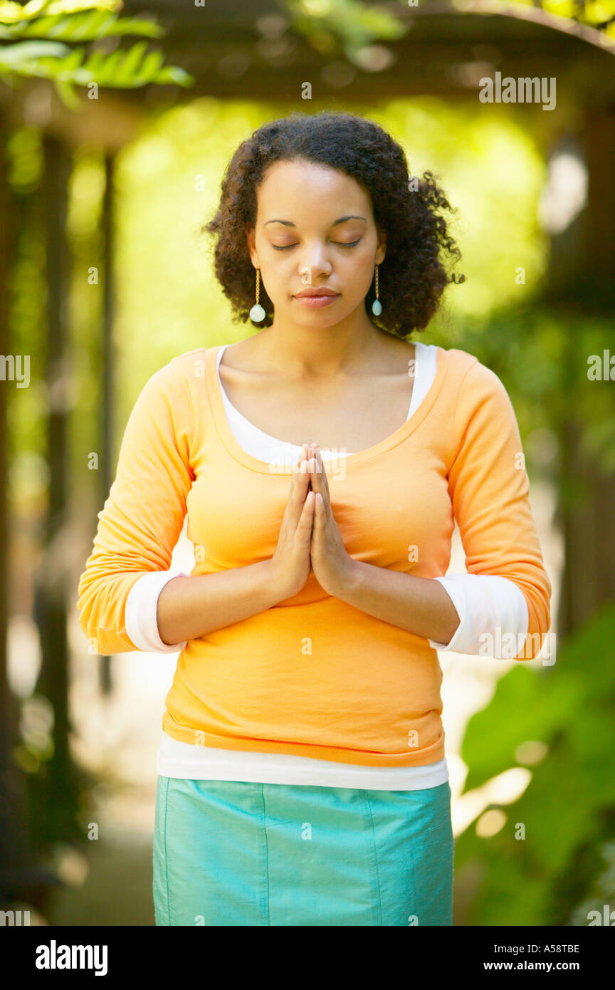 One young black woman praying hi-res stock photography and images - Alamy