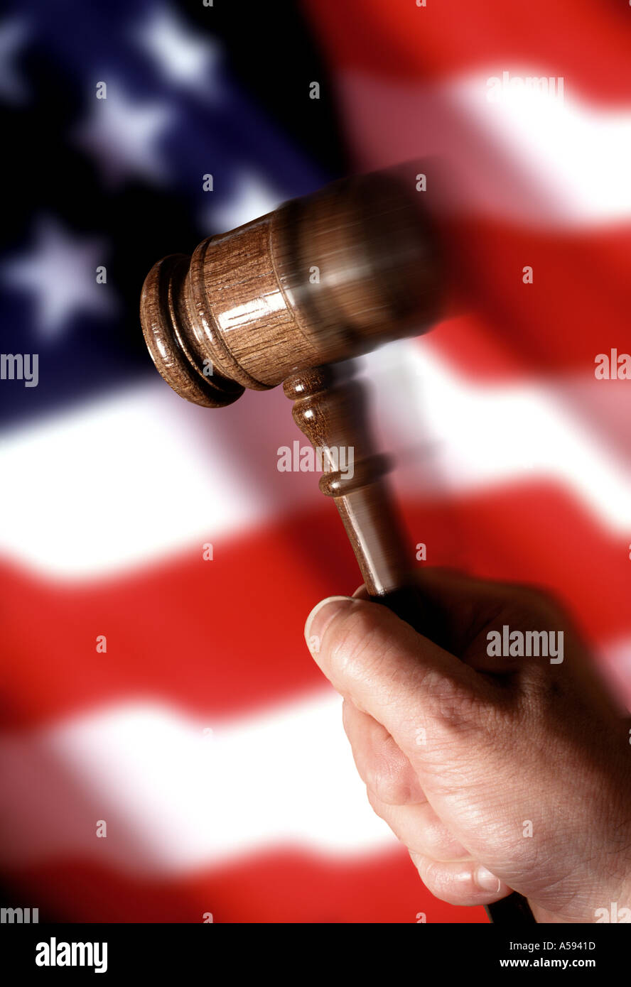 hand moving a gavel with US flag background Stock Photo