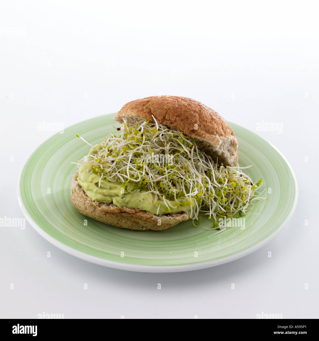 Wholemeal bap with guacamole and alfalfa shoots Stock Photo