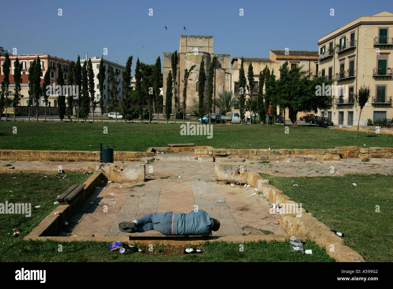 Man sleeping on a bench at early morning Palermo Sicily Stock Photo