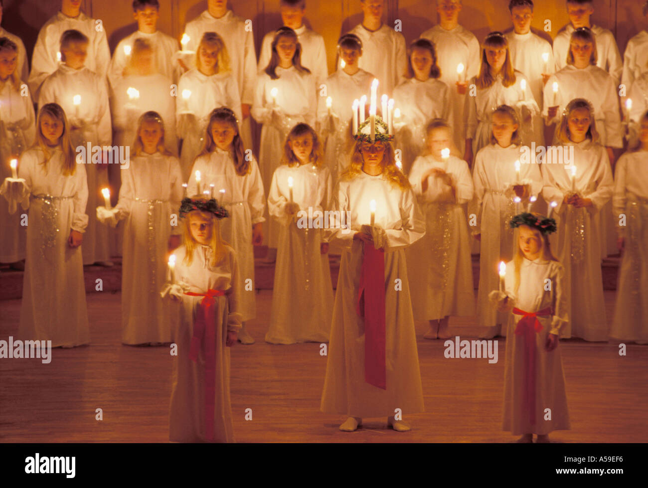 Children with candles singing Santa Lucia songs on December 13 in Sweden Stock Photo