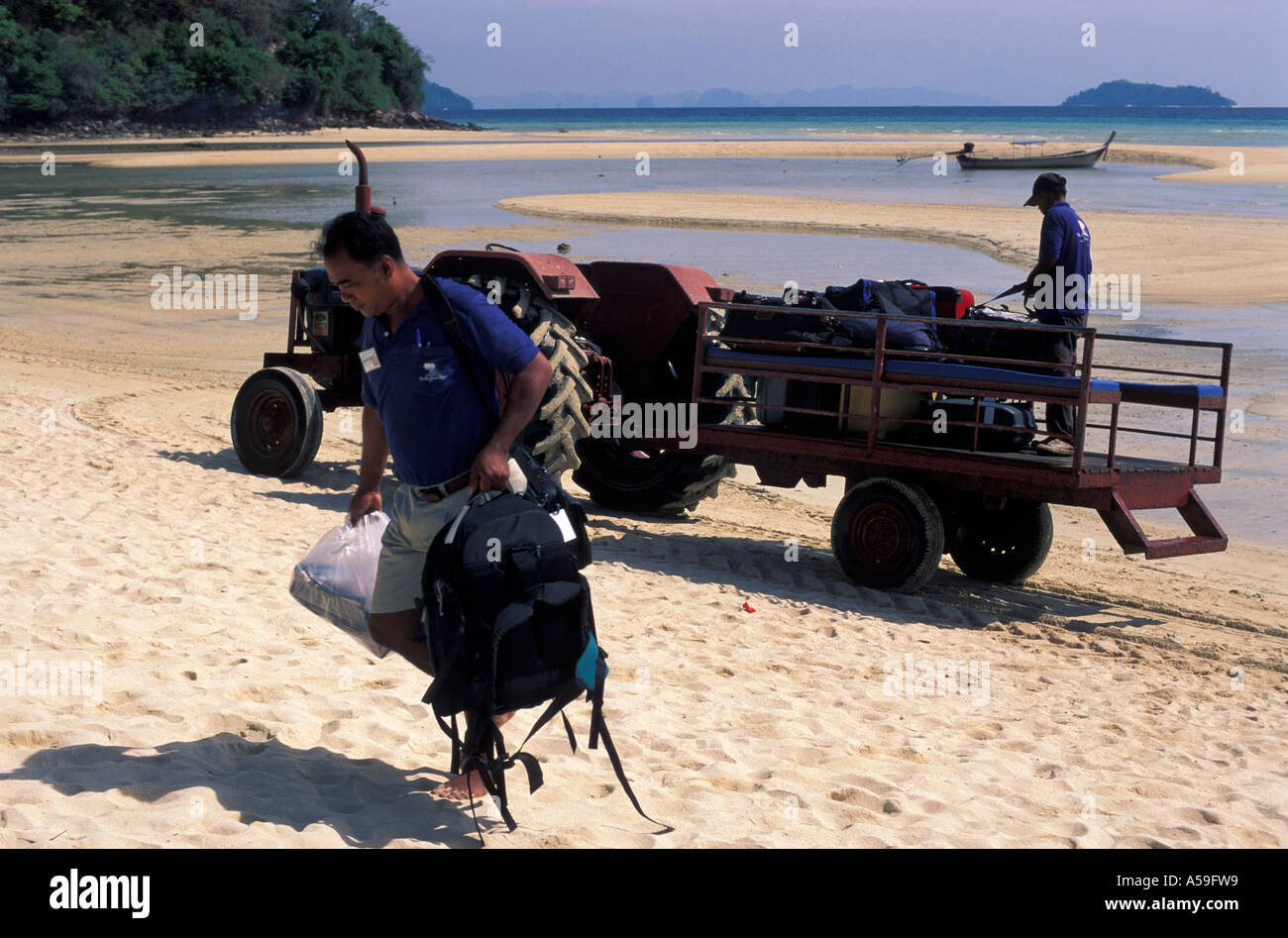 Natives of Maldives offload the holiday luggage Stock Photo Alamy