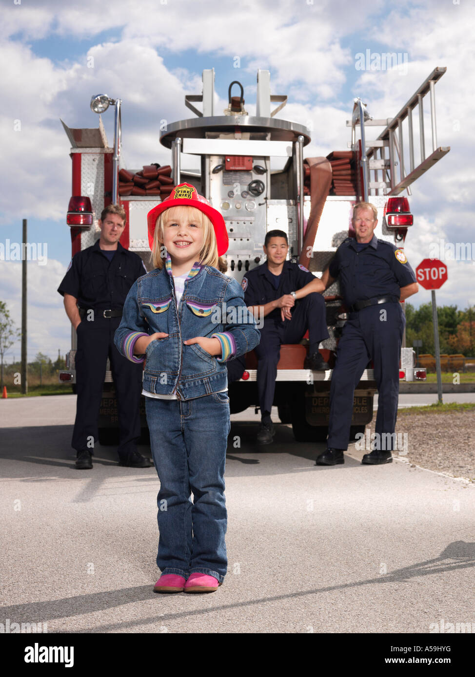 Portrait of Girl with Fire Fighters Stock Photo