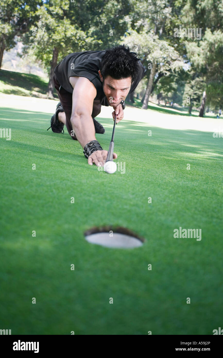 Man Playing Pool on Golf Course Stock Photo