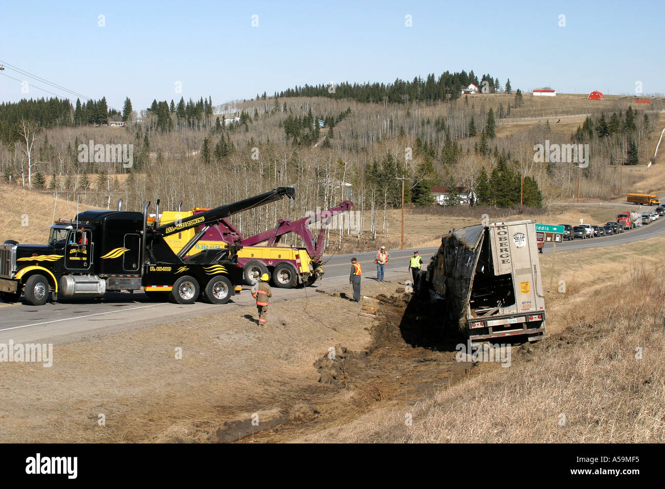 ACCIDENT VEHICULAR; tow truck pulling cattleliner out of the ditch Stock Photo