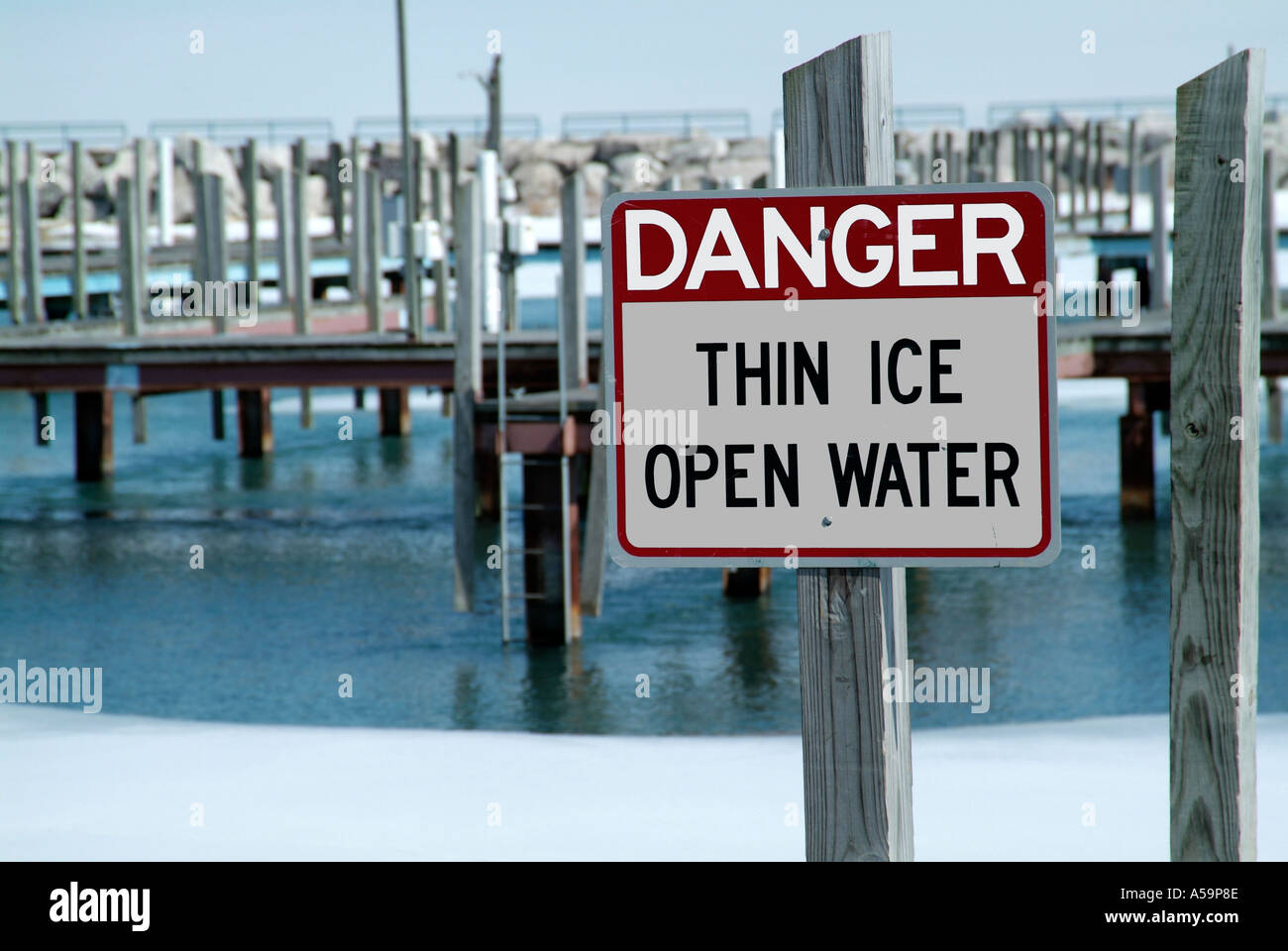 Sign indicating danger thin ice and open water Stock Photo - Alamy