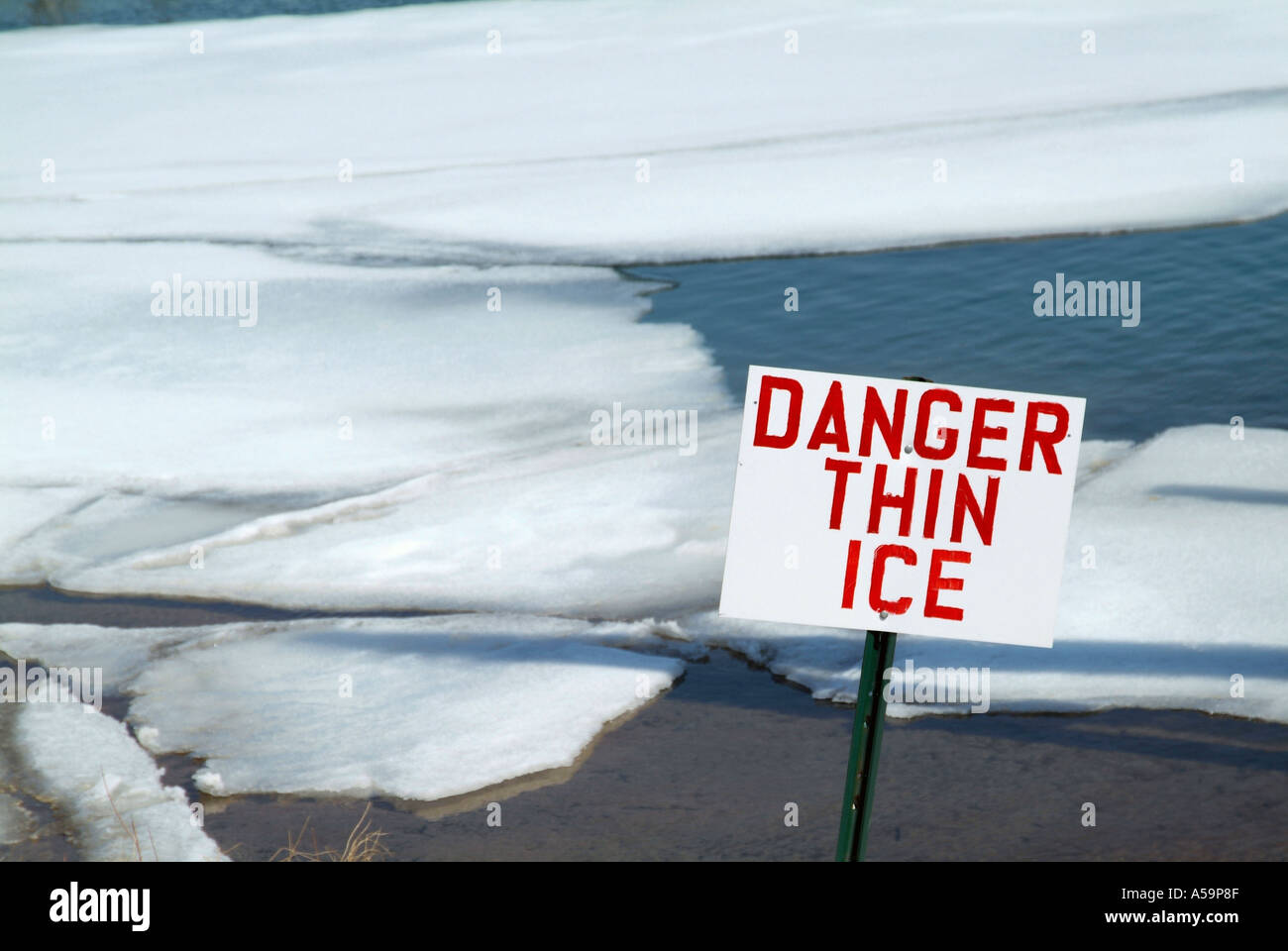 Sign indicating danger thin ice and open water Stock Photo - Alamy