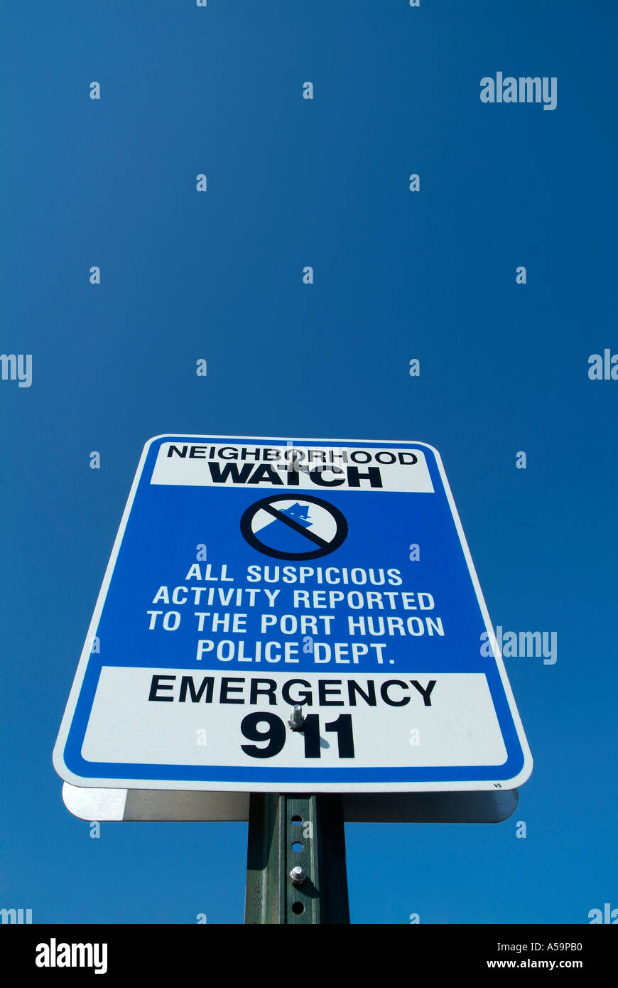 Neighborhood watch sign advises suspicious activity to be reported to 911 police Stock Photo
