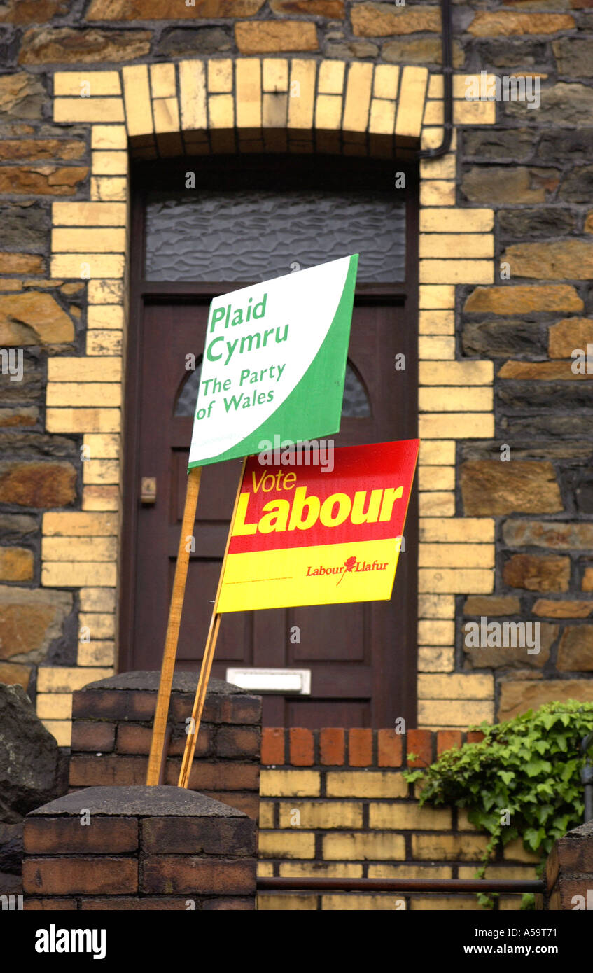 Plaid Cymru The Party of Wales and Wales Labour Party placards outside terraced houses in the Gwent South Wales Valleys UK Stock Photo