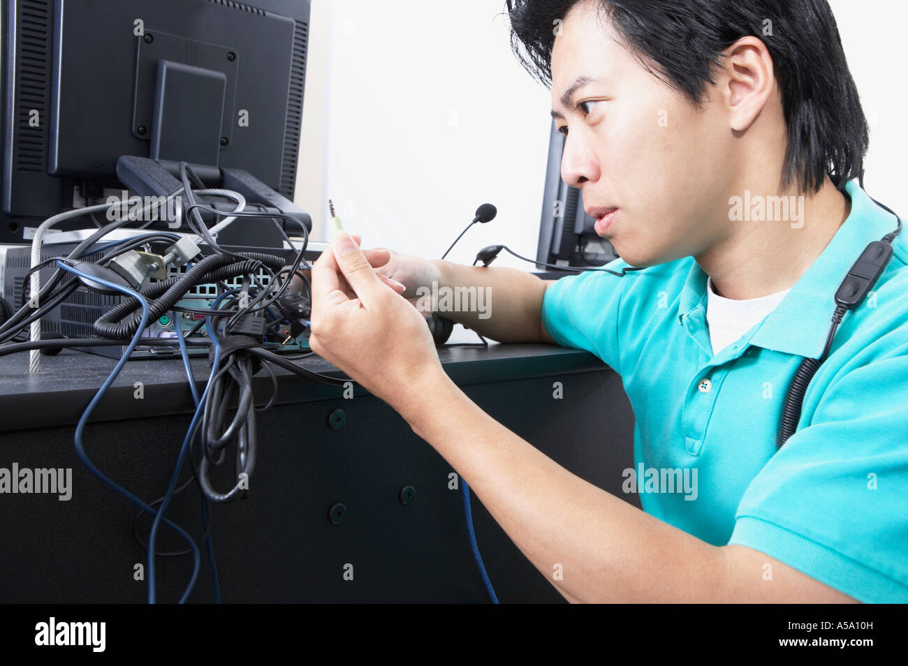 Asian male computer service technician with bundle of wires Stock Photo ...