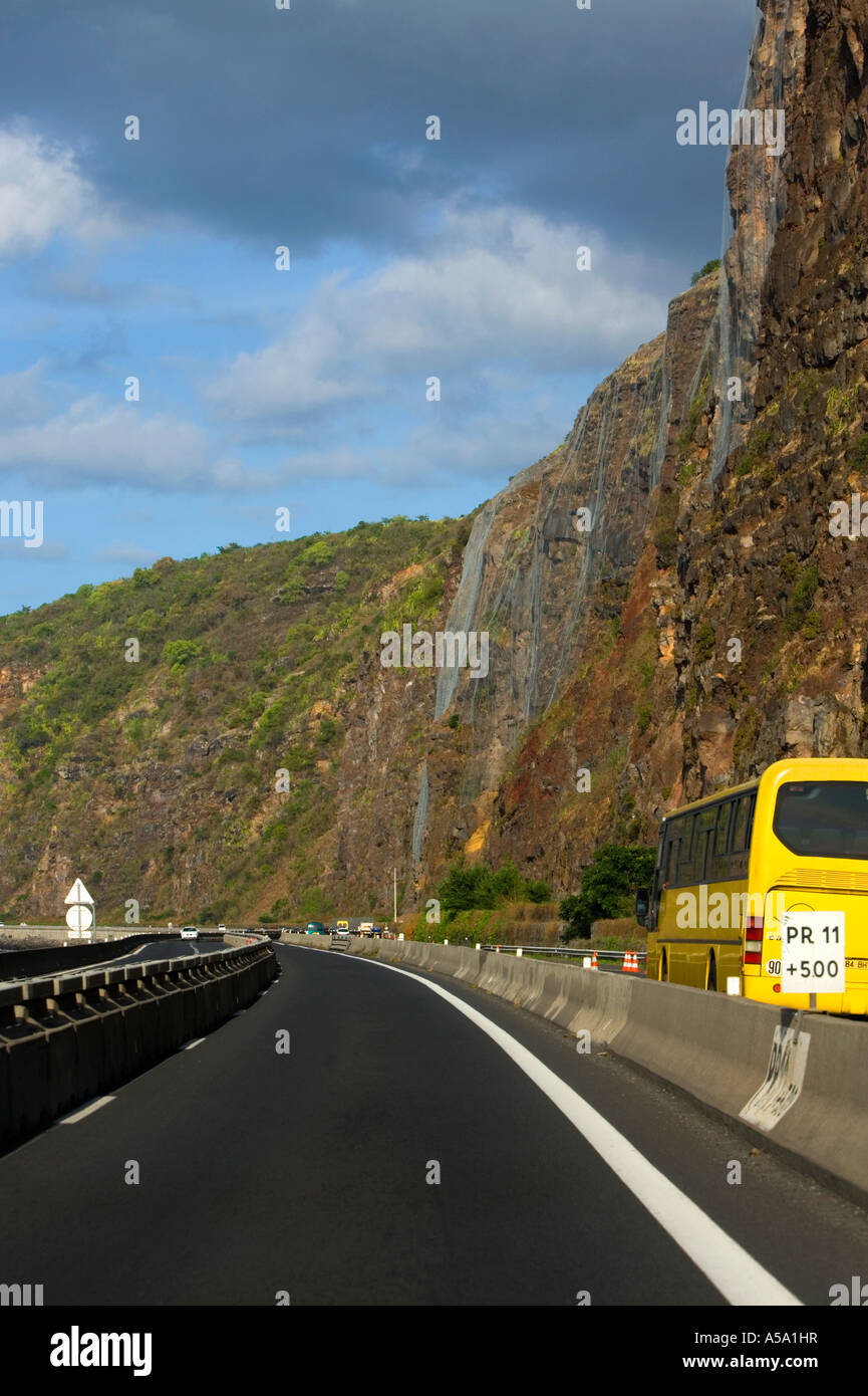 Defensive wire netting against rock fall danger on coastal road in Réunion Stock Photo