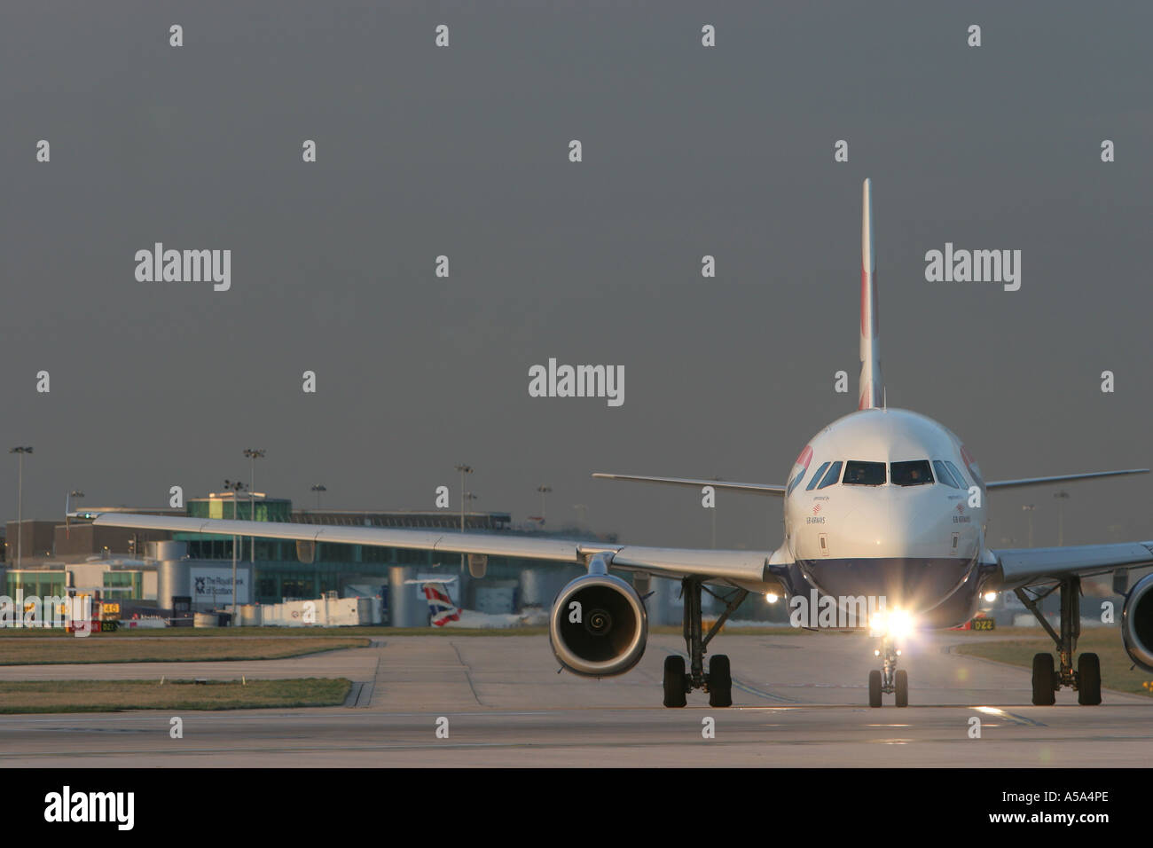 A British Airways plane taxes onto the runway at Manchester Airport preparing for take off Stock