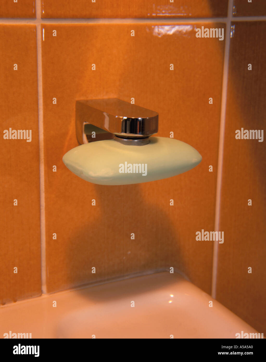 Wall mounted magnetic soap holder in a bathroom. Stock Photo