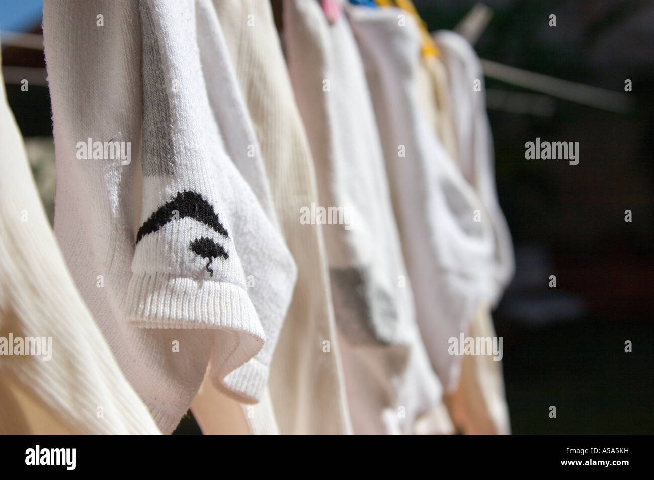 Socks hung from a clothesline to dry in the Sun Stock Photo - Alamy