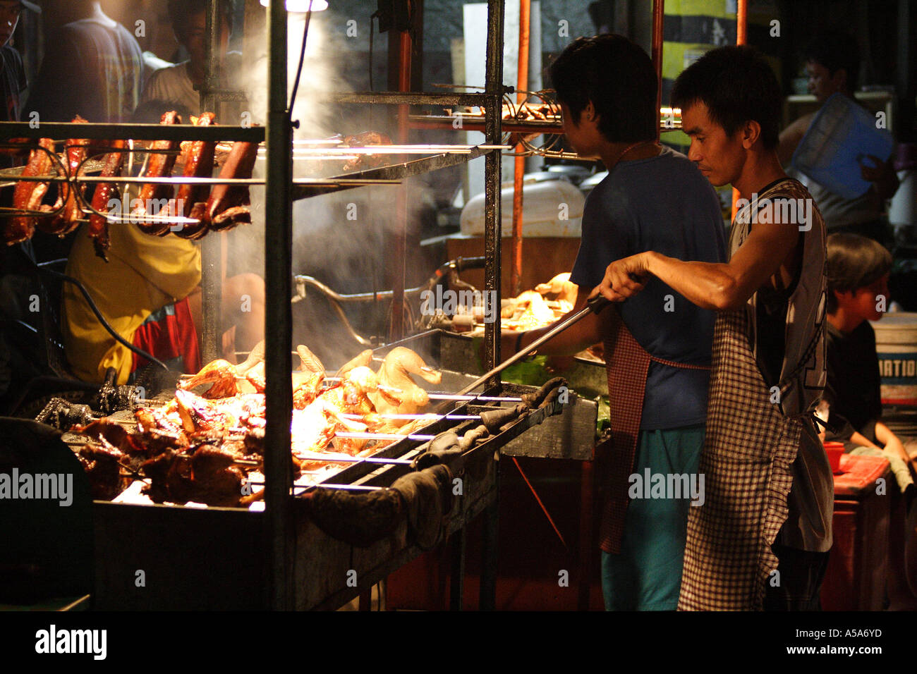 An outdoor BBQ grill selling delicious barbaque chicken, beef and pork, Fields Avenue, Angeles City, Philippine Islands Stock Photo