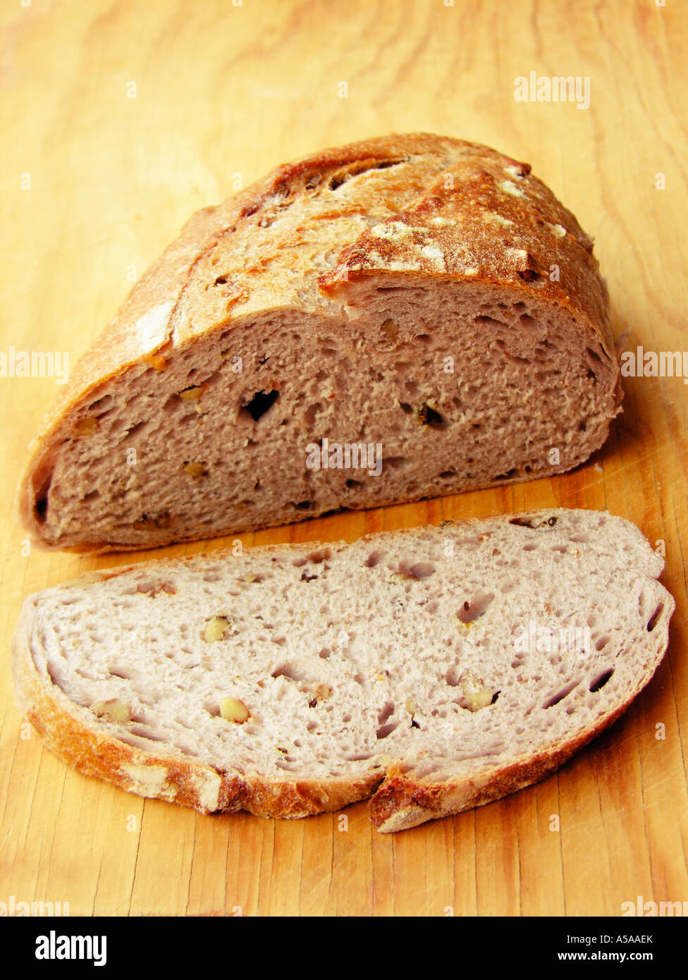 Wholemeal bread with walnuts on wooden board Stock Photo