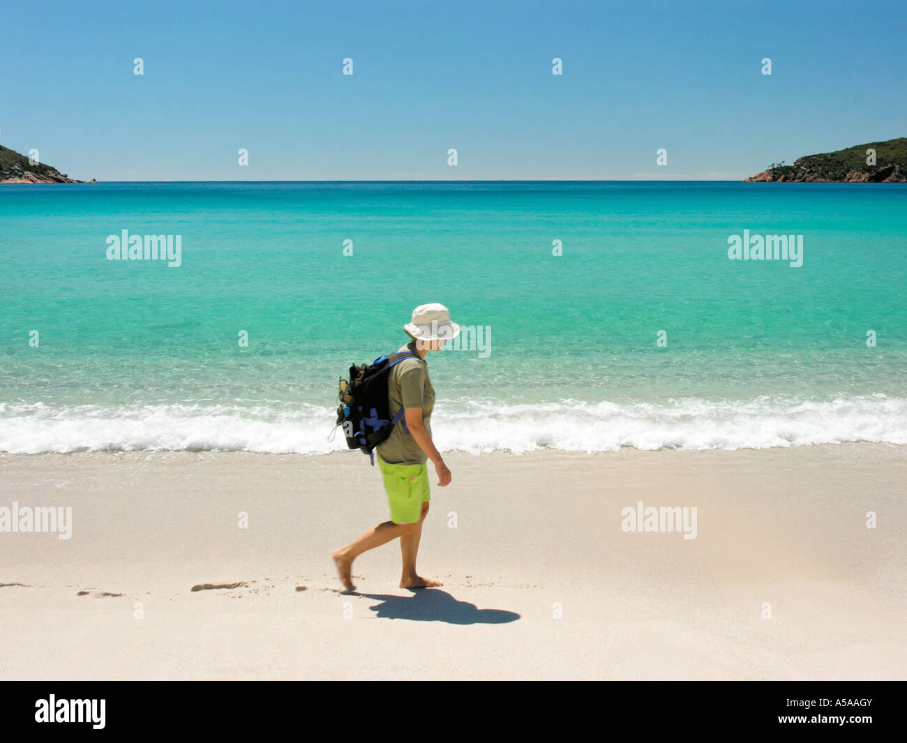 Woman walking barefoot along beach hi-res stock photography and images ...