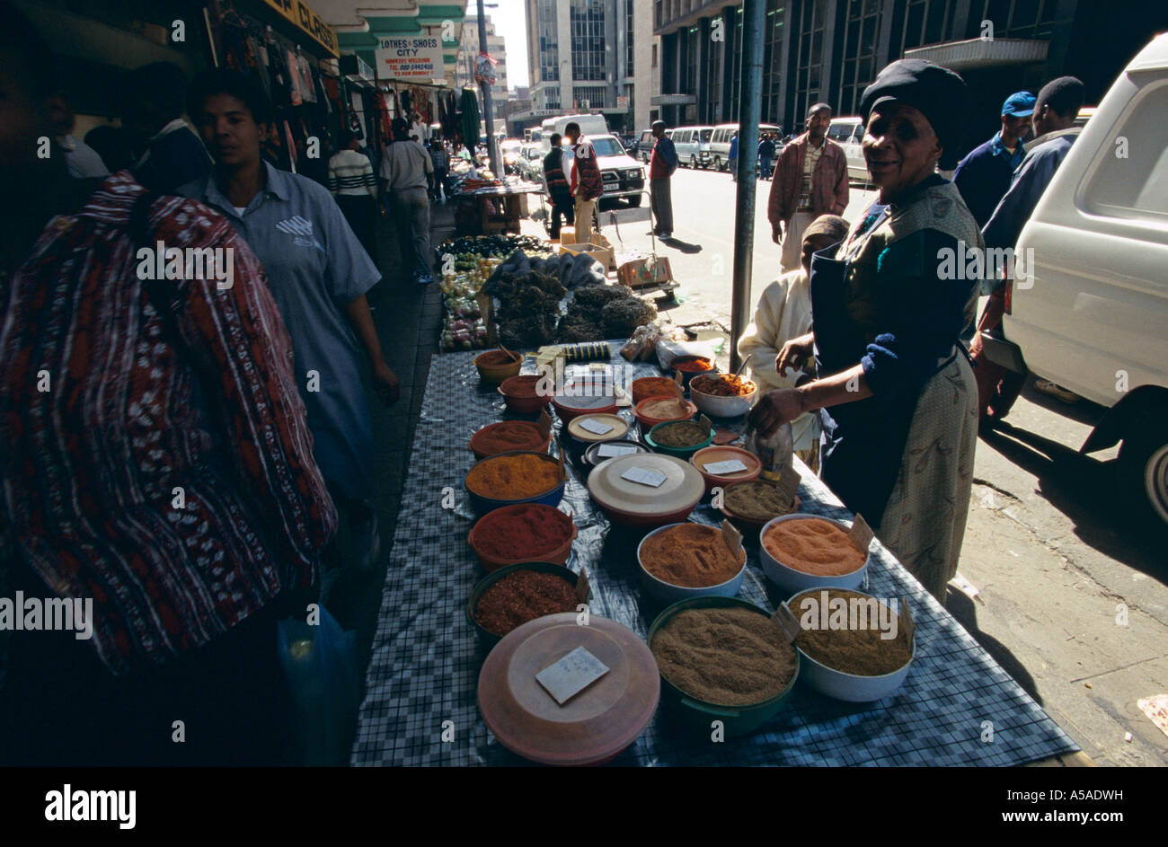 Vendor selling colourful South African spices at street market, Johannesburg, South Africa Stock