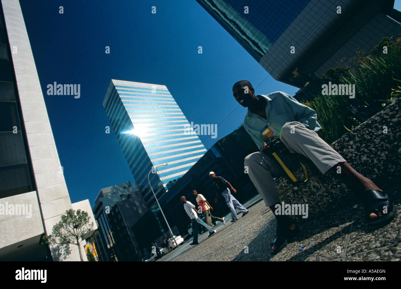A man sitting at a square in Johannesburg with his camera Stock Photo