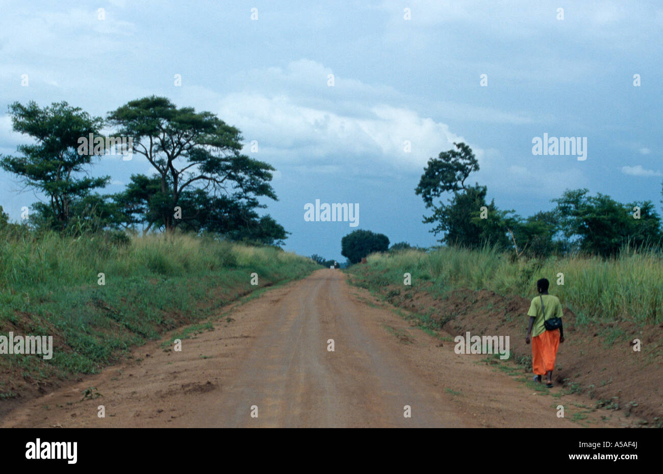 A woman walking alone in the countryside of Northern Uganda Stock Photo