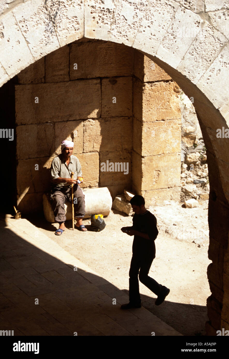 A man walking on a pavement in Syria Stock Photo